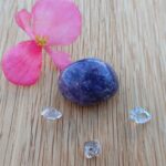 Pink flower, purple polished stone and clear crystals