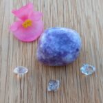 Purple tumbled stone with clear crystals and pink flower