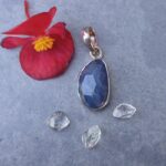 Blue gemstone pendant with flower and crystals