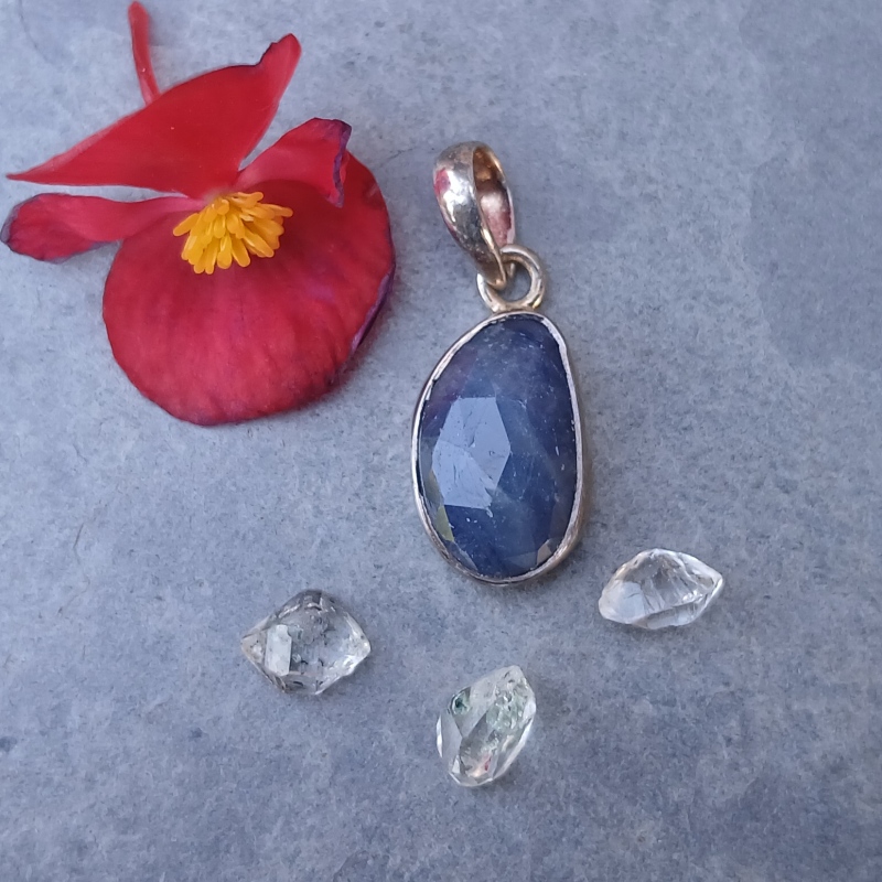 Blue gemstone pendant with flower and crystals