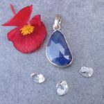 Blue gemstone pendant with flower and crystals