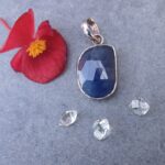 Blue gemstone pendant with red flower and crystals