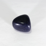 Polished blue goldstone gemstone on white background