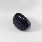 Polished dark blue goldstone on white background