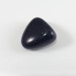 Polished dark blue glittering stone on white background
