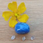 Yellow flower with blue stone and crystals