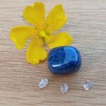 Yellow flower with blue stone and crystals