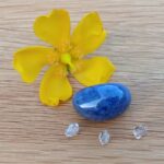 Yellow flower with blue stone and crystals
