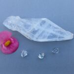 Clear quartz crystal with pink flower and gemstones