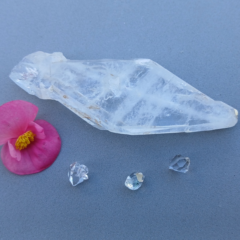 Clear quartz crystal with pink flower and gemstones