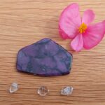 Purple polished stone with pink flower and crystals