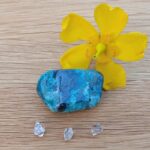 Blue polished stone with yellow flower and crystals