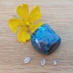 Yellow flower with blue polished stone and crystals