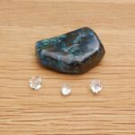 Blue-green stone with three clear crystals