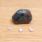 Polished opal stone with three clear crystals