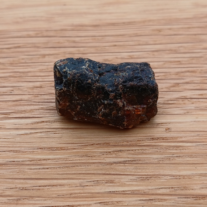 Rough dark brown stone on wooden surface