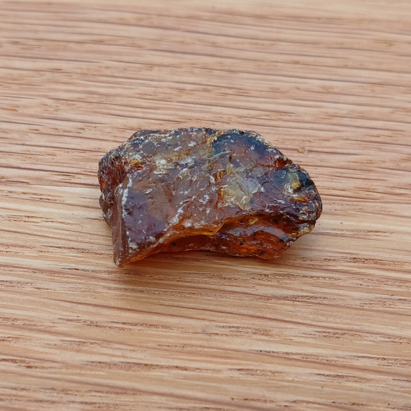 Small amber stone on wooden surface