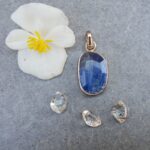 Blue gemstone pendant with flower and crystals