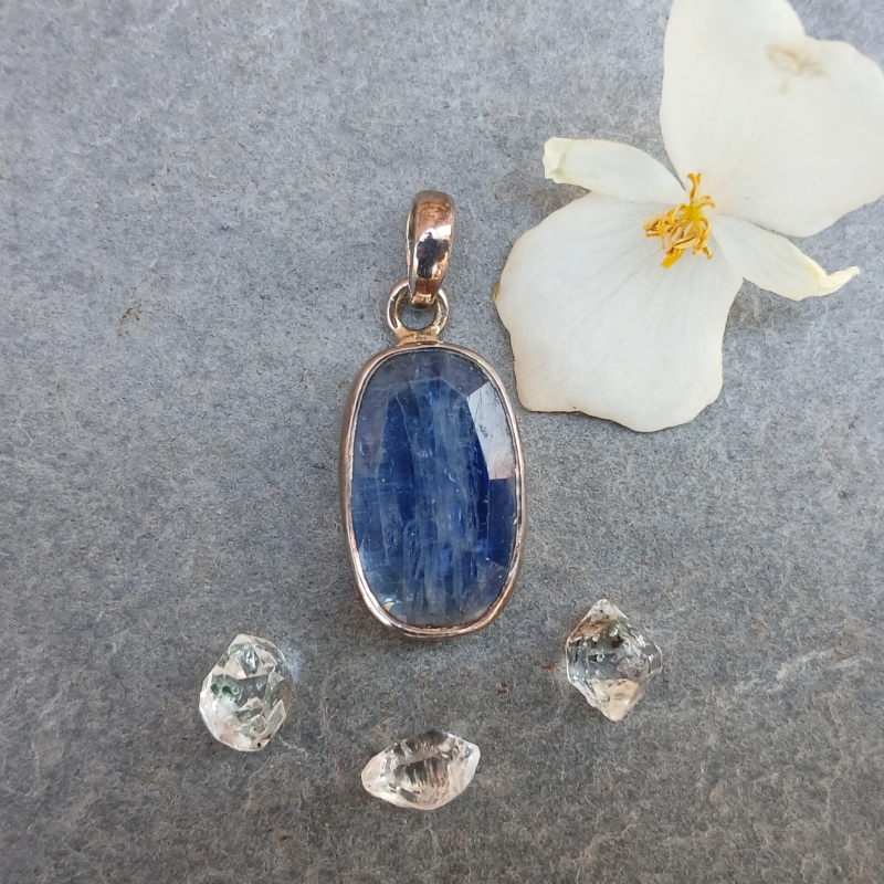 Blue gemstone pendant with flower and crystals