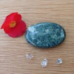 Red flower, green stone and clear crystals