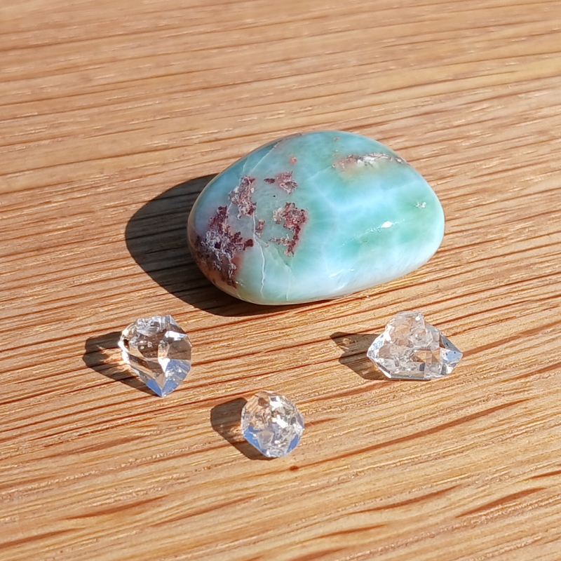 Polished turquoise stone with three clear crystals