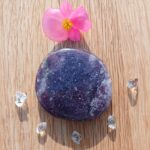 Purple polished stone with pink flower and clear crystals