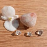 White flower, polished stone and clear crystals