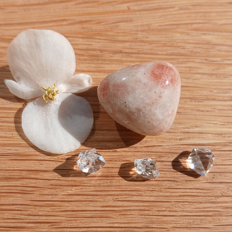 White flower, polished stone and clear crystals