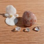 White flower and crystals on wooden surface