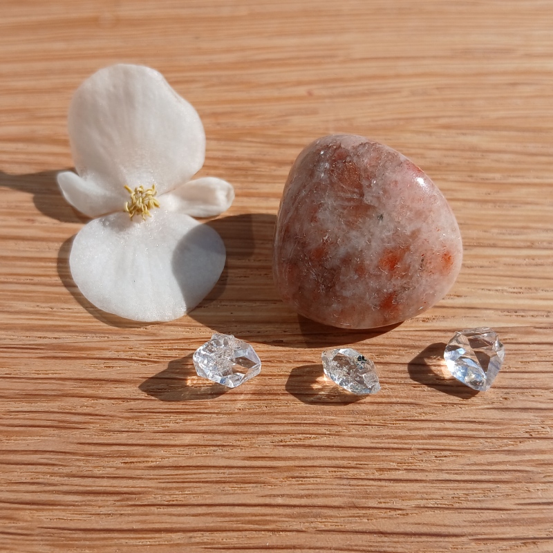 White flower and crystals on wooden surface