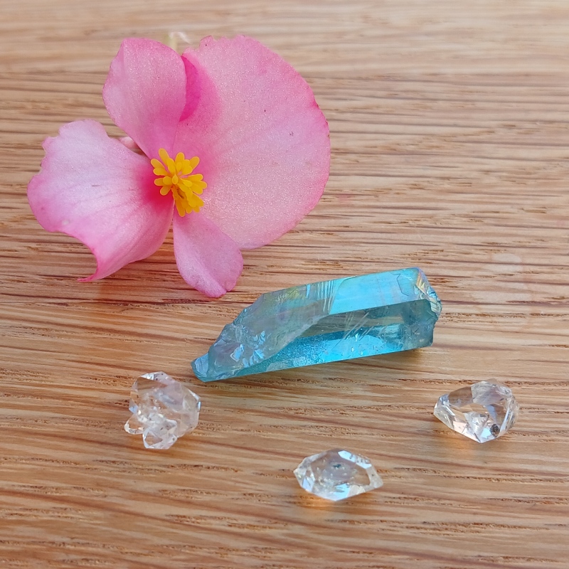 Pink flower with blue crystal and clear gemstones