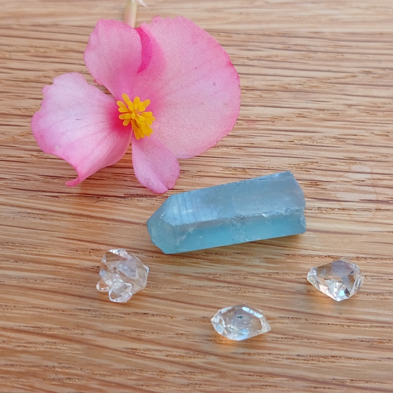 Pink flower with blue crystal and clear gemstones
