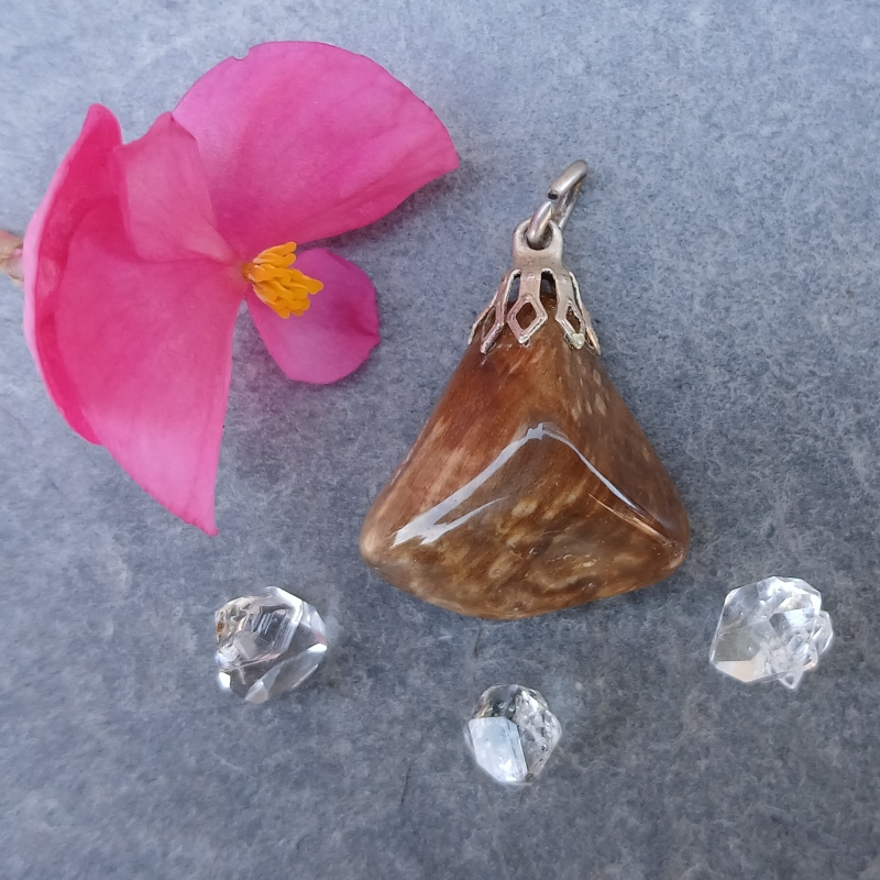 Brown polished stone pendant with pink flower and clear crystals