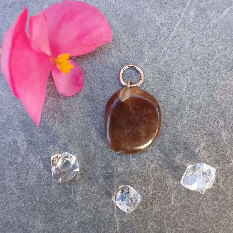 Brown polished stone pendant with pink flower and crystals