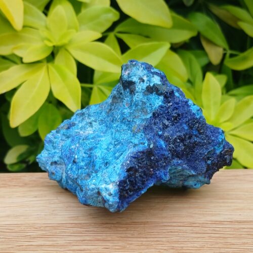 Vivid blue mineral specimen on wooden surface