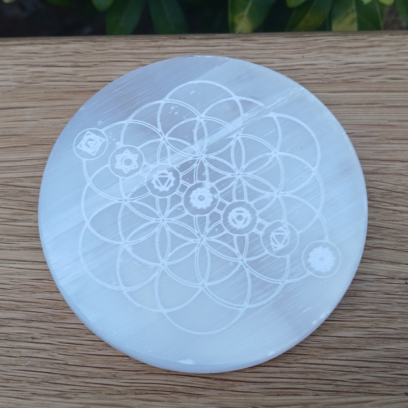 Engraved circular selenite plate with sacred geometry design